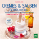 Cover des Buches 'Cremes & Salben selbst gerührt' mit einer weißen Creme in einem Tiegel, daneben Blütenblätter und dahinter weitere kleine Fläschchen und Gläser