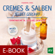 Cover des E-Books 'Cremes & Salben selbst gerührt' mit einer weißen Creme in einem Tiegel, daneben Blütenblätter und dahinter weitere kleine Fläschchen und Gläser
